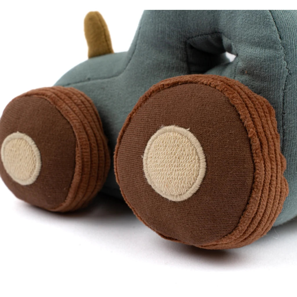 Toy car made of fabric with a green body and brown wheels on a white background