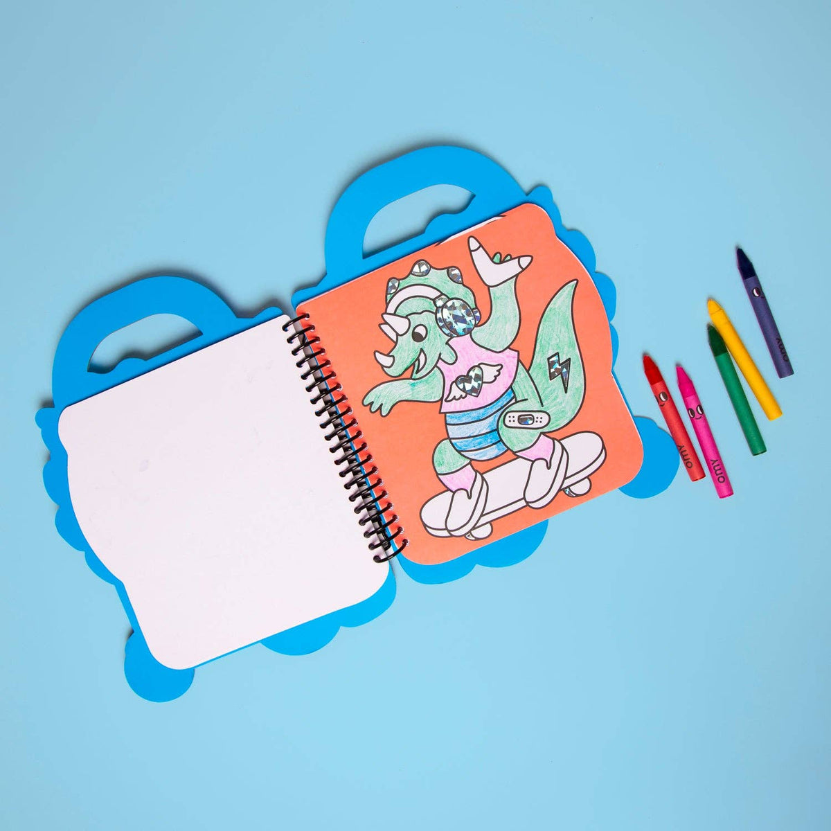 Coloring book with a cartoon character on a blue background, surrounded by markers.